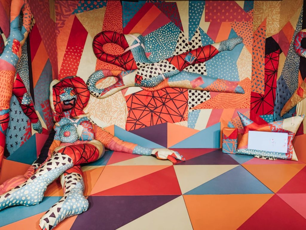 Kolorowa instalacja przedstawiająca manekina-nożyczki.